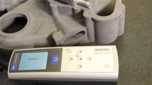 Operator using the Handysurf+ E35 portable surface finish tester to check roughness