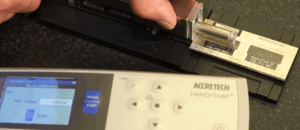 Close-up of stylus setup during surface finish calibration.